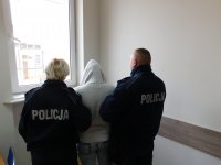 Umundurowani Policjanci wprowadzili zatrzymaną kobietę do pomieszczenia, w którym sporządzą dokumentację służbową.