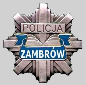 Gwiazda policyjna, a w środku napis POLICJA ZAMBRÓW.