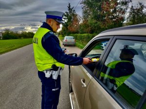 Policjant Ruchu Drogowego podczas badania stanu trzeźwości kierowcy.