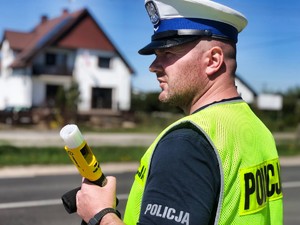 policjant z urządzeniem do badania stanu trzeźwości